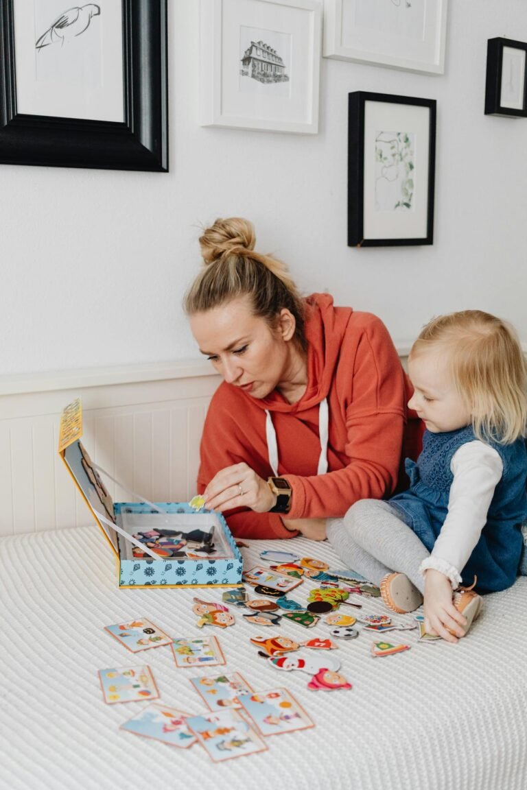 Mother and child enjoying a playful moment with an interactive book indoors.
